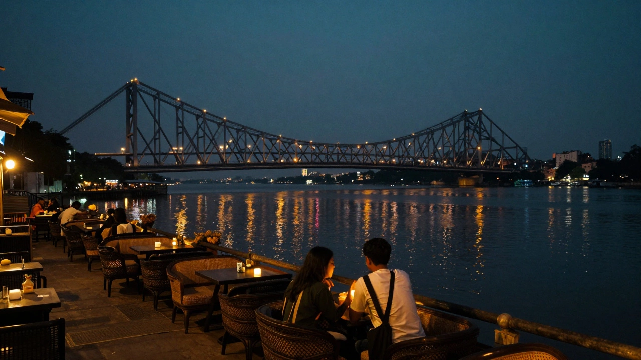 Couple dining by Hooghly River with lit Howrah Bridge in background